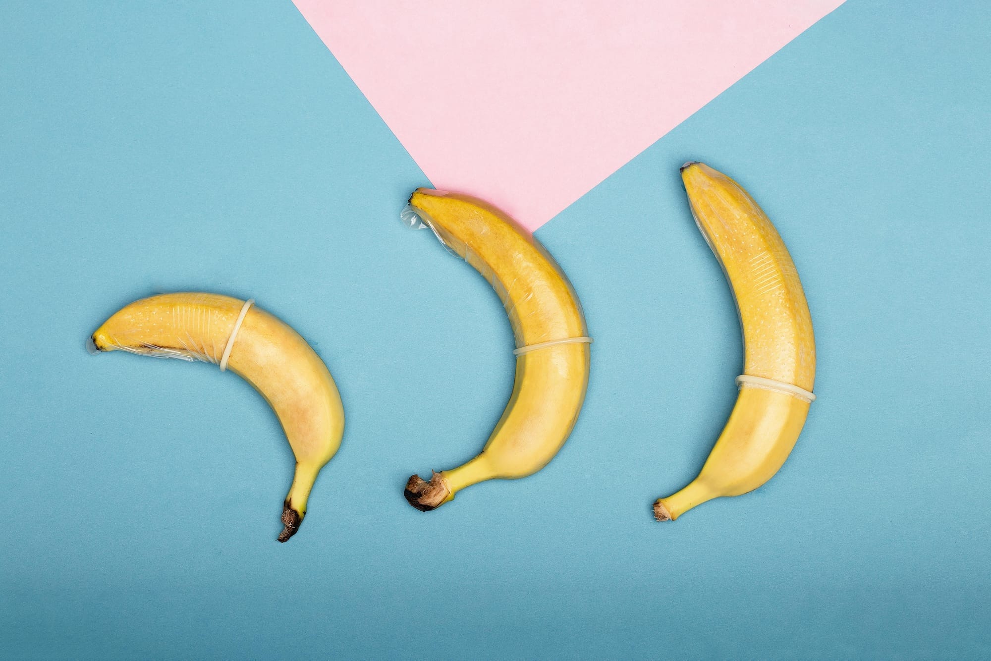 Three bananas with condoms demonstrating safe sex practices.